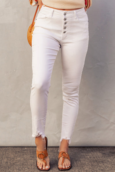 Frayed cropped denim jeans give flattering trendy style.